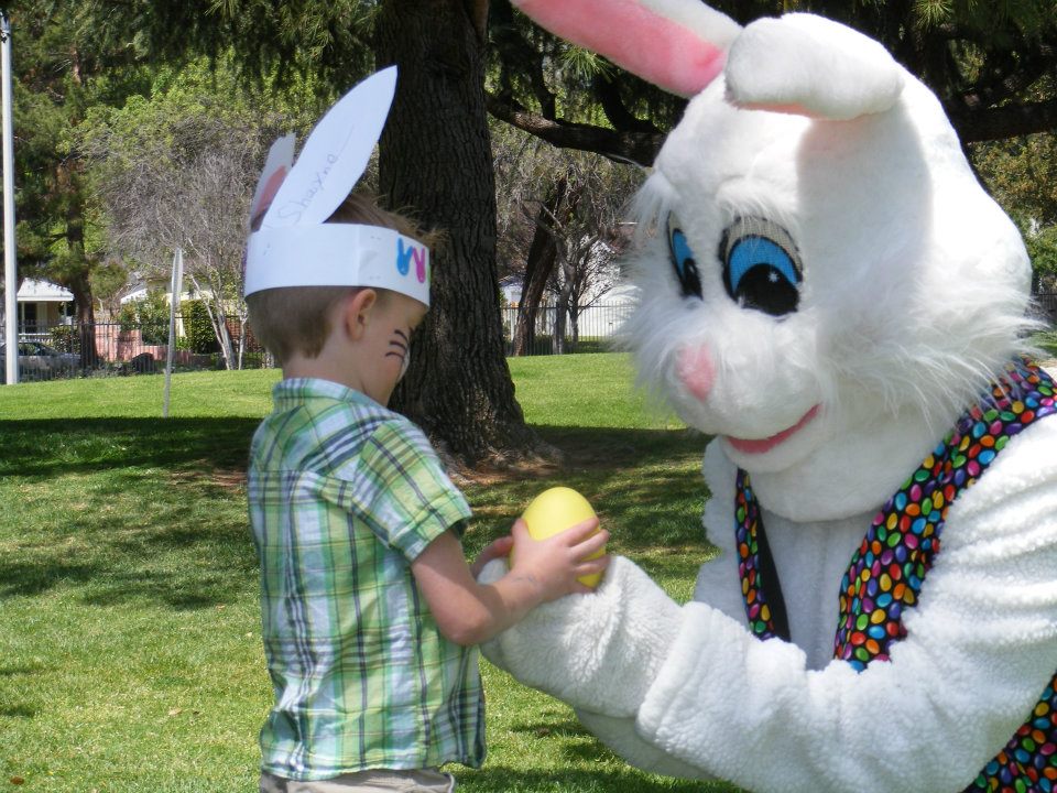 Easter Bunny Helping A Boy With Easter Egg Hunt